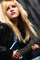 woman with guitar seated glamour fashion photo